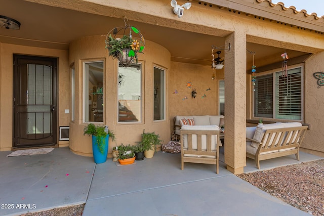 doorway to property with outdoor lounge area, a patio, and stucco siding