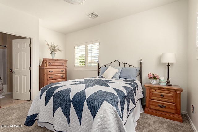 bedroom with light tile patterned floors, light carpet, visible vents, and baseboards