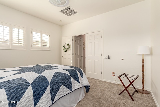 bedroom featuring light carpet, visible vents, and baseboards