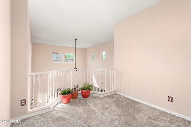 empty room with baseboards and carpet