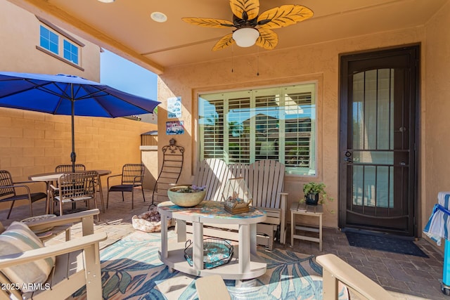view of patio / terrace with fence, ceiling fan, and outdoor dining space