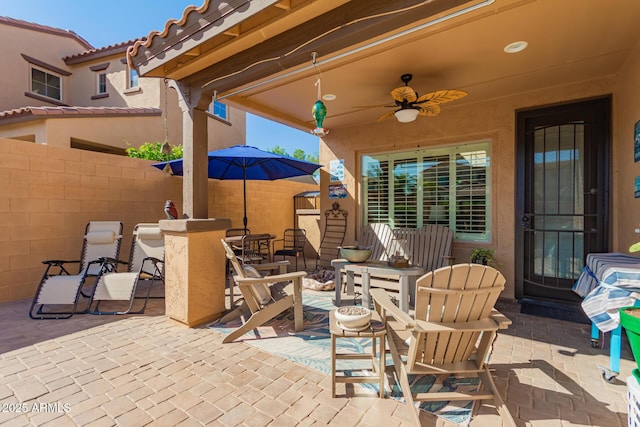 view of patio / terrace with fence and ceiling fan