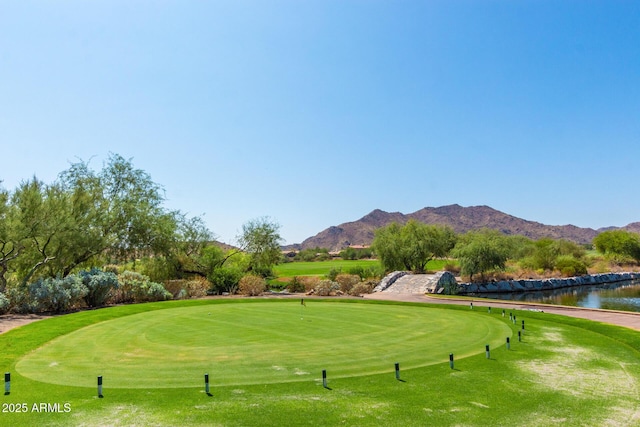 surrounding community with a mountain view and view of golf course