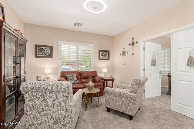 carpeted living area featuring visible vents