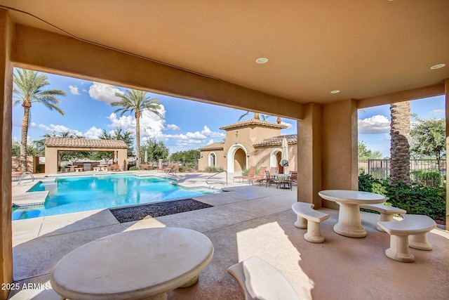 view of swimming pool with a gazebo, a patio area, a fenced in pool, and fence