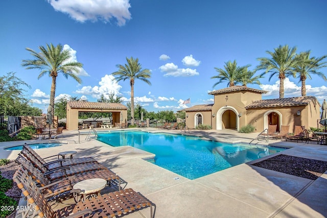 community pool featuring a gazebo, fence, and a patio