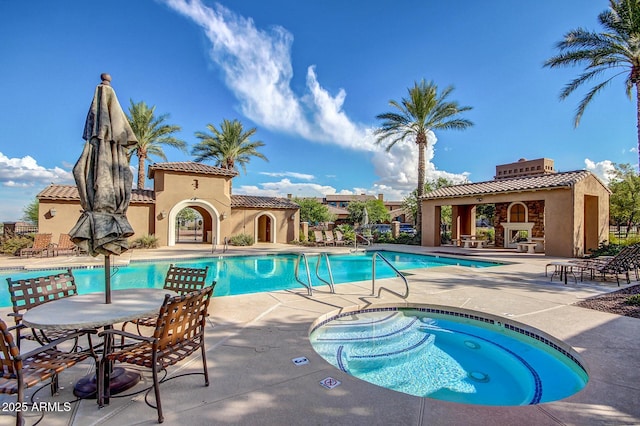 community pool with a community hot tub, a gazebo, and a patio