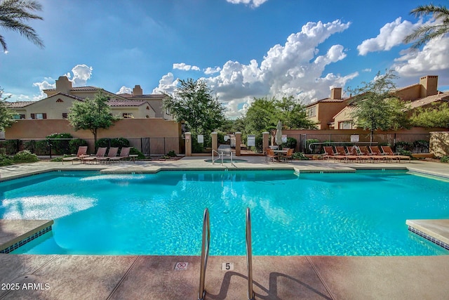 pool featuring fence, a residential view, and a patio