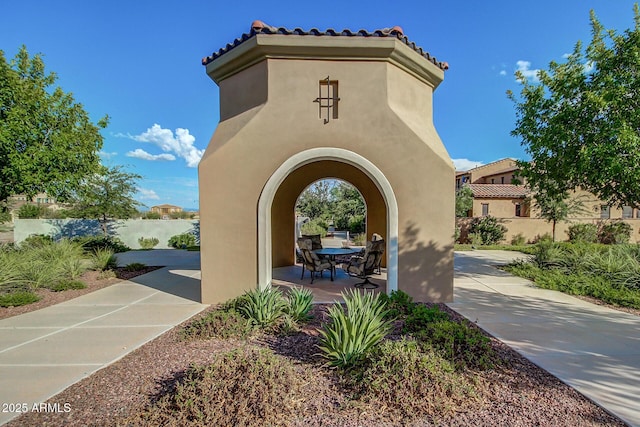 view of home's community with a patio and fence