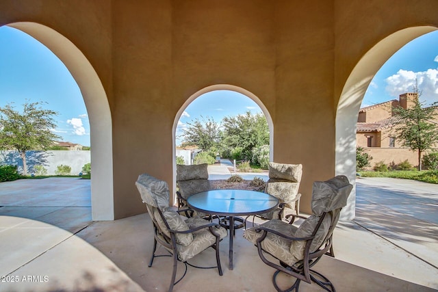 view of patio with fence and outdoor dining space