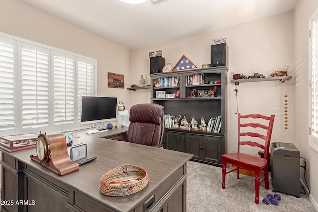 office area with plenty of natural light and light carpet