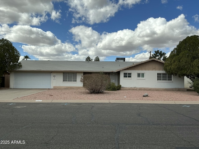 ranch-style home with an attached garage and concrete driveway