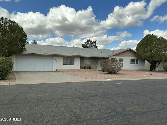 ranch-style house with a garage and concrete driveway