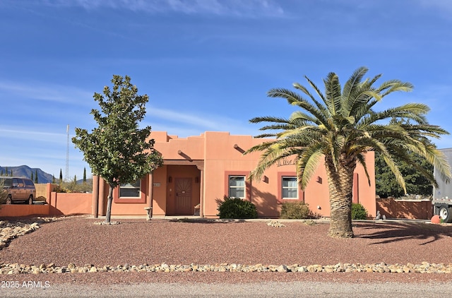 pueblo-style house featuring a mountain view