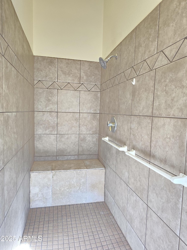 bathroom with a tile shower