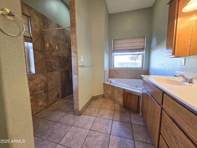 bathroom with tile patterned floors, vanity, and independent shower and bath