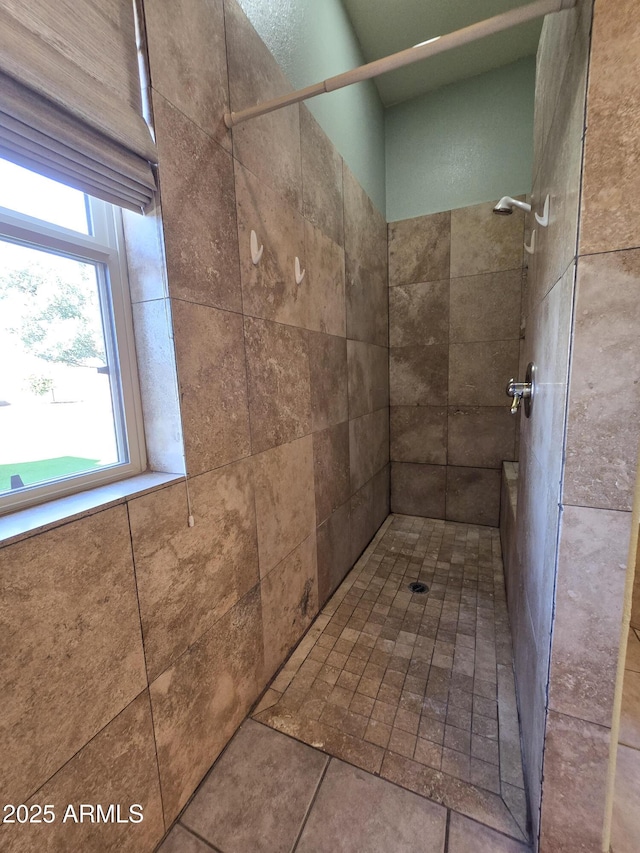 bathroom with a tile shower