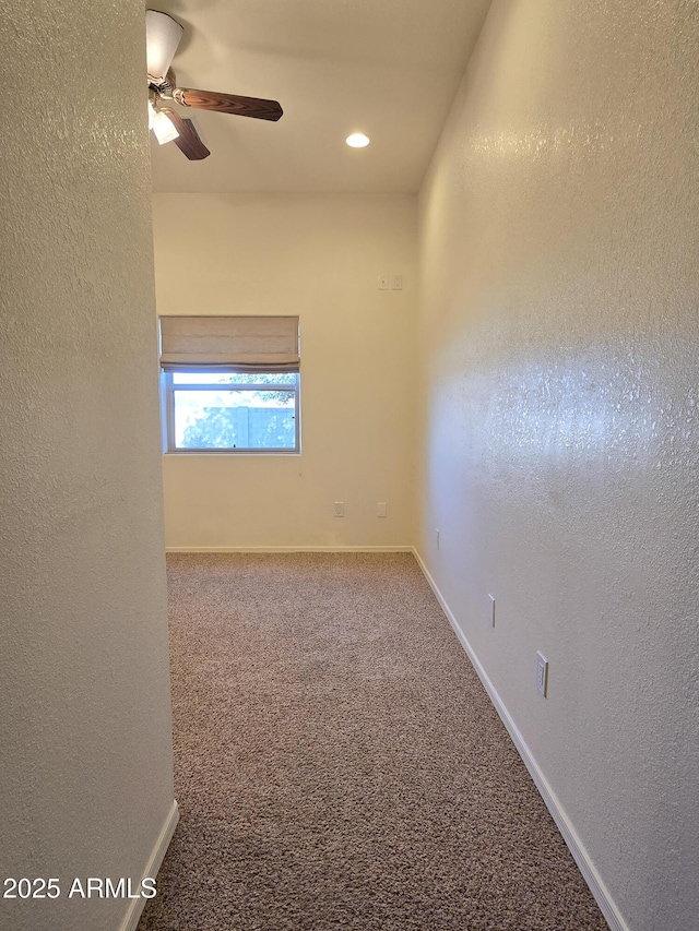 empty room featuring carpet and ceiling fan