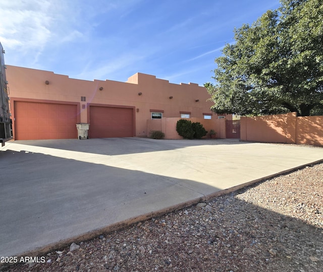 pueblo-style house with a garage