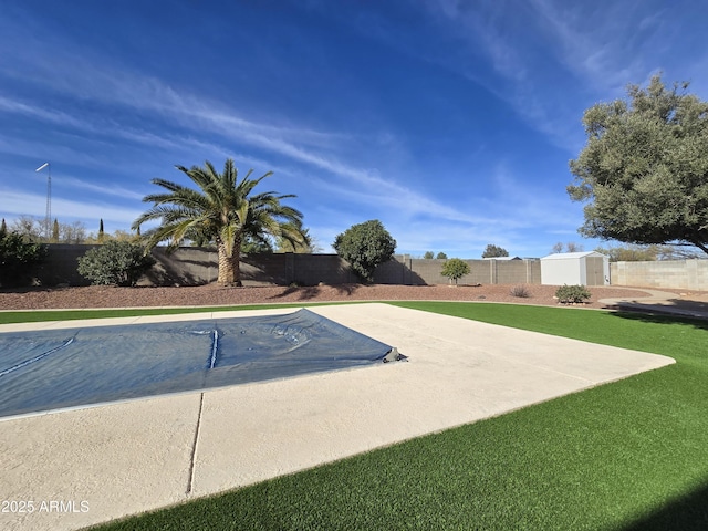 view of swimming pool featuring a shed