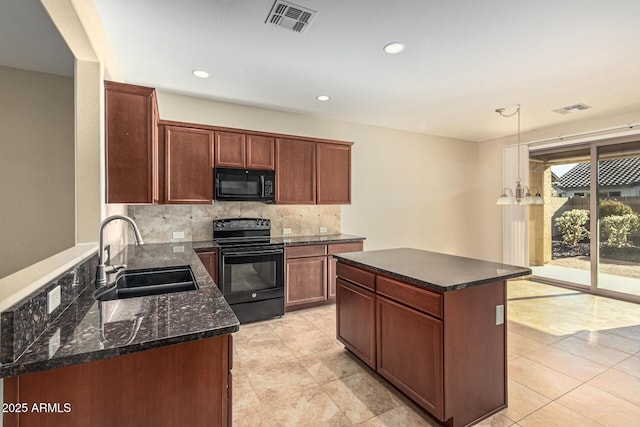 kitchen with a kitchen island, a sink, visible vents, decorative backsplash, and black appliances