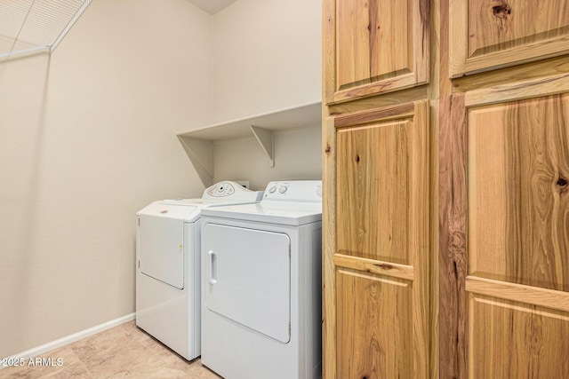 laundry area featuring laundry area, separate washer and dryer, and baseboards