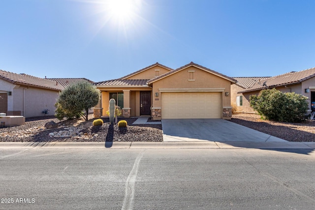 ranch-style house featuring a tile roof, stucco siding, an attached garage, stone siding, and driveway