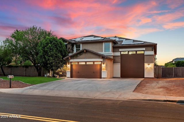 3944 W Paradise Ln, Phoenix, AZ 85053 - view of front facade with stucco siding, a garage, driveway, and roof mounted solar panels