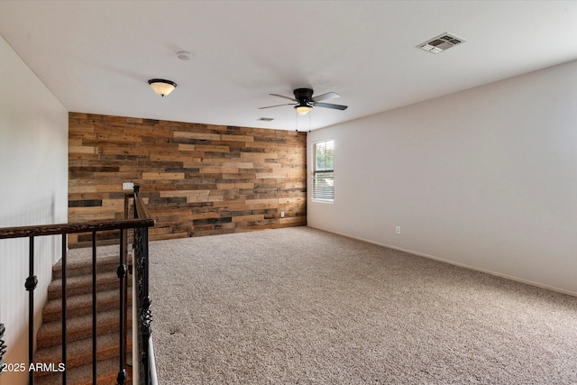 3944 W Paradise Ln, Phoenix, AZ 85053 - spare room with wood walls, carpet floors, a ceiling fan, and a smoke detector
