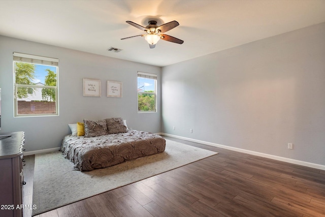 3944 W Paradise Ln, Phoenix, AZ 85053 - bedroom with multiple windows, dark wood finished floors, and ceiling fan