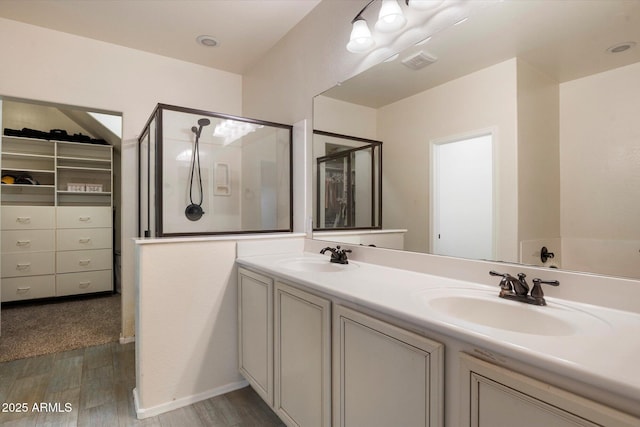 3944 W Paradise Ln, Phoenix, AZ 85053 - full bathroom with double vanity, wood finished floors, a walk in shower, and a walk in closet