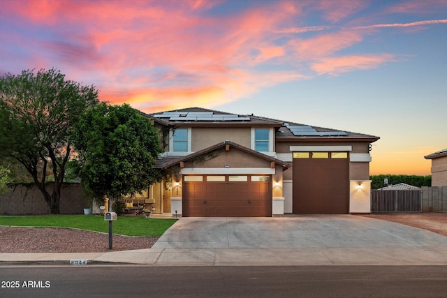 3944 W Paradise Ln, Phoenix, AZ 85053 - view of front facade with driveway, solar panels, an attached garage, and stucco siding