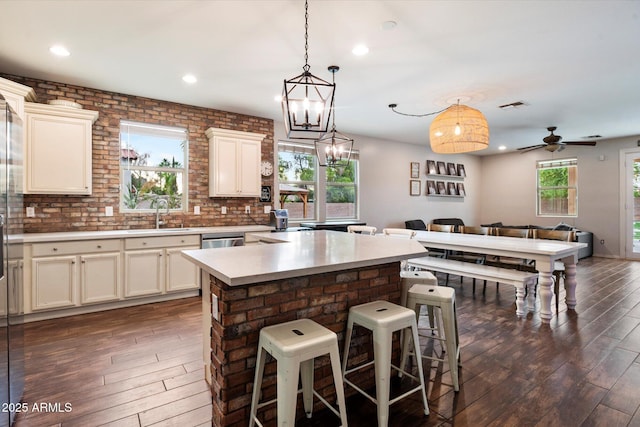 3944 W Paradise Ln, Phoenix, AZ 85053 - kitchen featuring dark wood-type flooring, open floor plan, light countertops, recessed lighting, and a kitchen bar