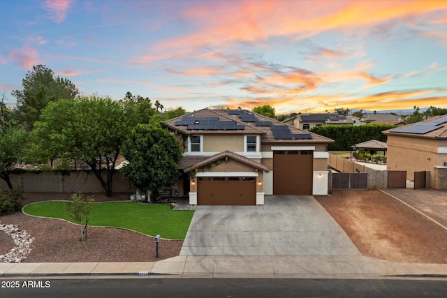 3944 W Paradise Ln, Phoenix, AZ 85053 - view of front of home with a gate, solar panels, stucco siding, concrete driveway, and a tiled roof