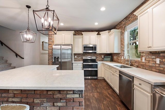 3944 W Paradise Ln, Phoenix, AZ 85053 - kitchen featuring stainless steel appliances, a chandelier, dark wood-type flooring, decorative light fixtures, and recessed lighting