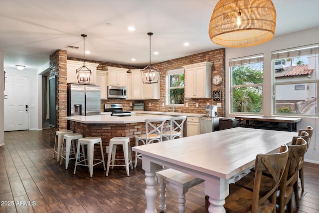3944 W Paradise Ln, Phoenix, AZ 85053 - kitchen with appliances with stainless steel finishes, a kitchen island, light countertops, decorative backsplash, and recessed lighting