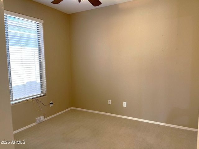 empty room featuring carpet and ceiling fan