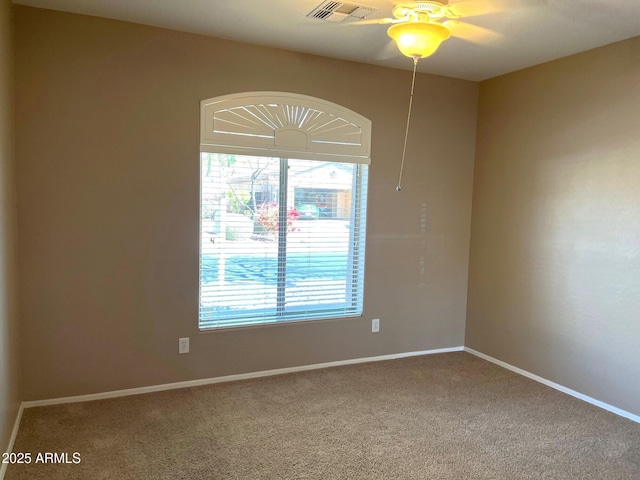 spare room with carpet floors and ceiling fan