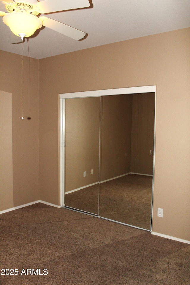 unfurnished bedroom with a closet, ceiling fan, and carpet