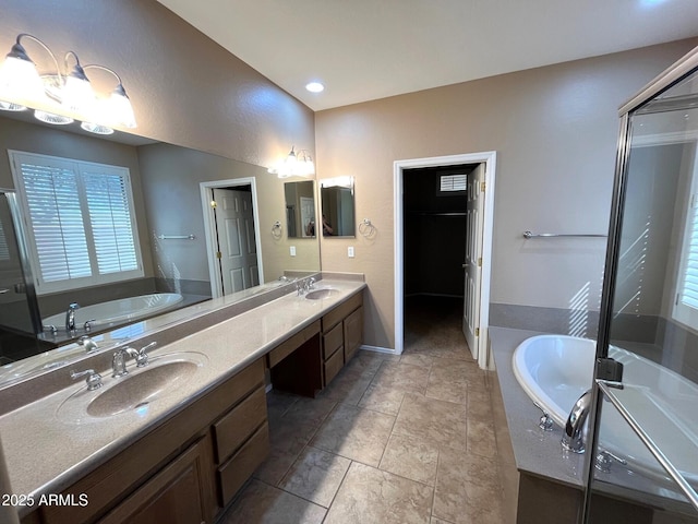 bathroom with vanity and shower with separate bathtub