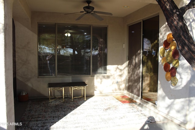 doorway to property with ceiling fan and a patio