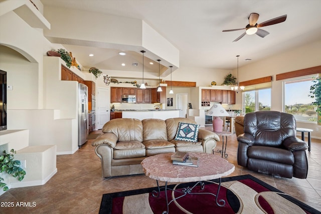 living room with arched walkways, recessed lighting, baseboards, and ceiling fan