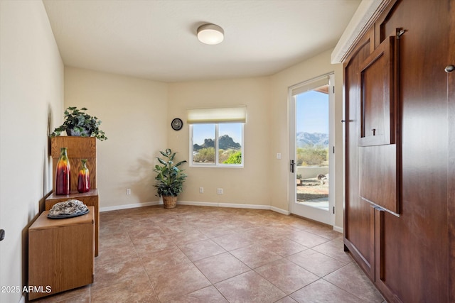 entrance foyer featuring light tile patterned floors and baseboards