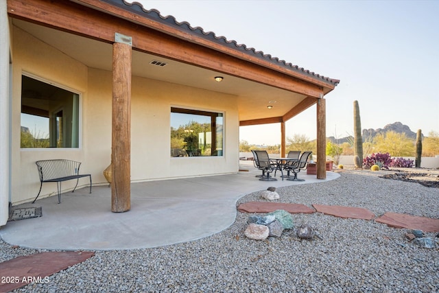 view of patio / terrace with a mountain view and visible vents