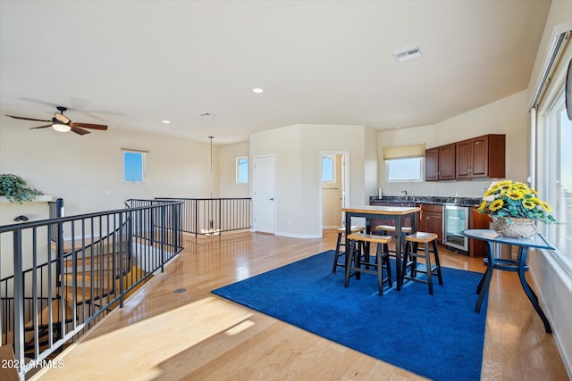 dining room with visible vents, beverage cooler, recessed lighting, light wood-style floors, and baseboards