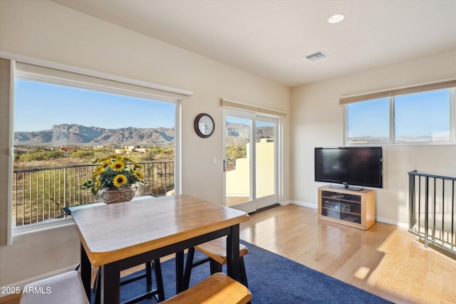 dining space with visible vents, baseboards, a healthy amount of sunlight, and wood finished floors