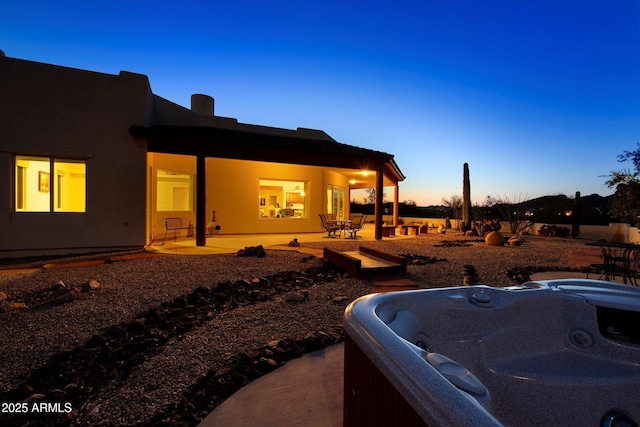 exterior space featuring a patio area and a hot tub