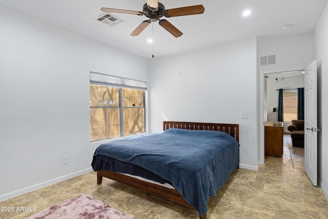 bedroom with stone finish floors, baseboards, and a ceiling fan