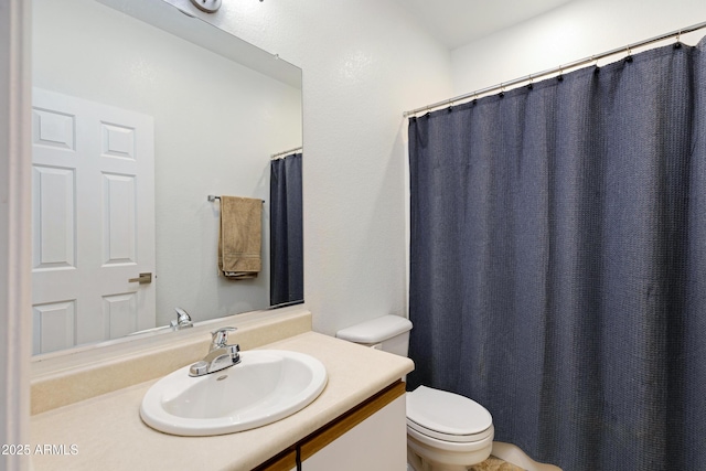 bathroom featuring toilet and vanity