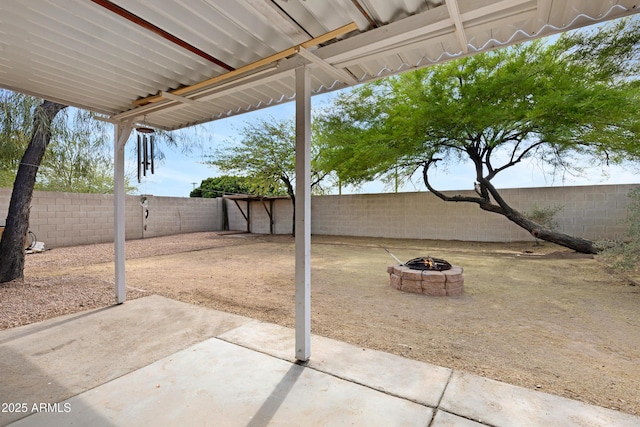 view of patio featuring an outdoor fire pit and a fenced backyard